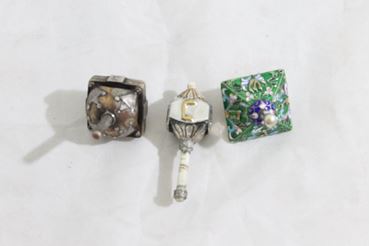 Picture of Lot 3 dreidels made of silver and bone. 20th century