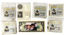 Picture of A $1 bill and 7 Hanuka Gelt bags